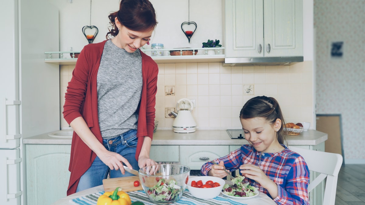 Family preparing healthy meals together in kitchen